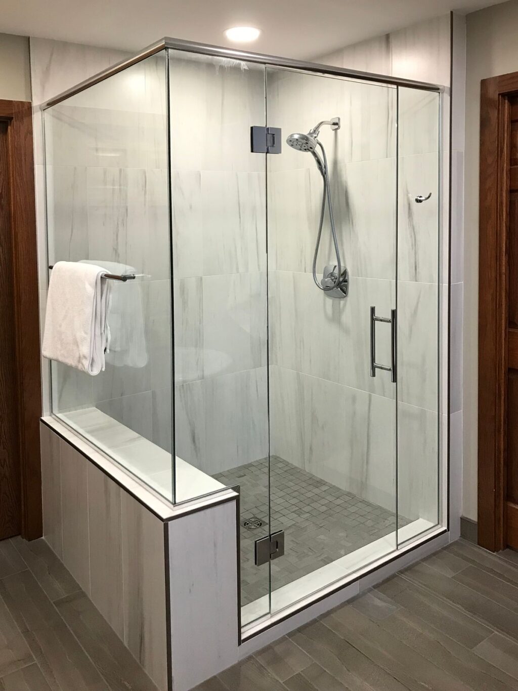 large bathroom shower with floor to ceiling tile