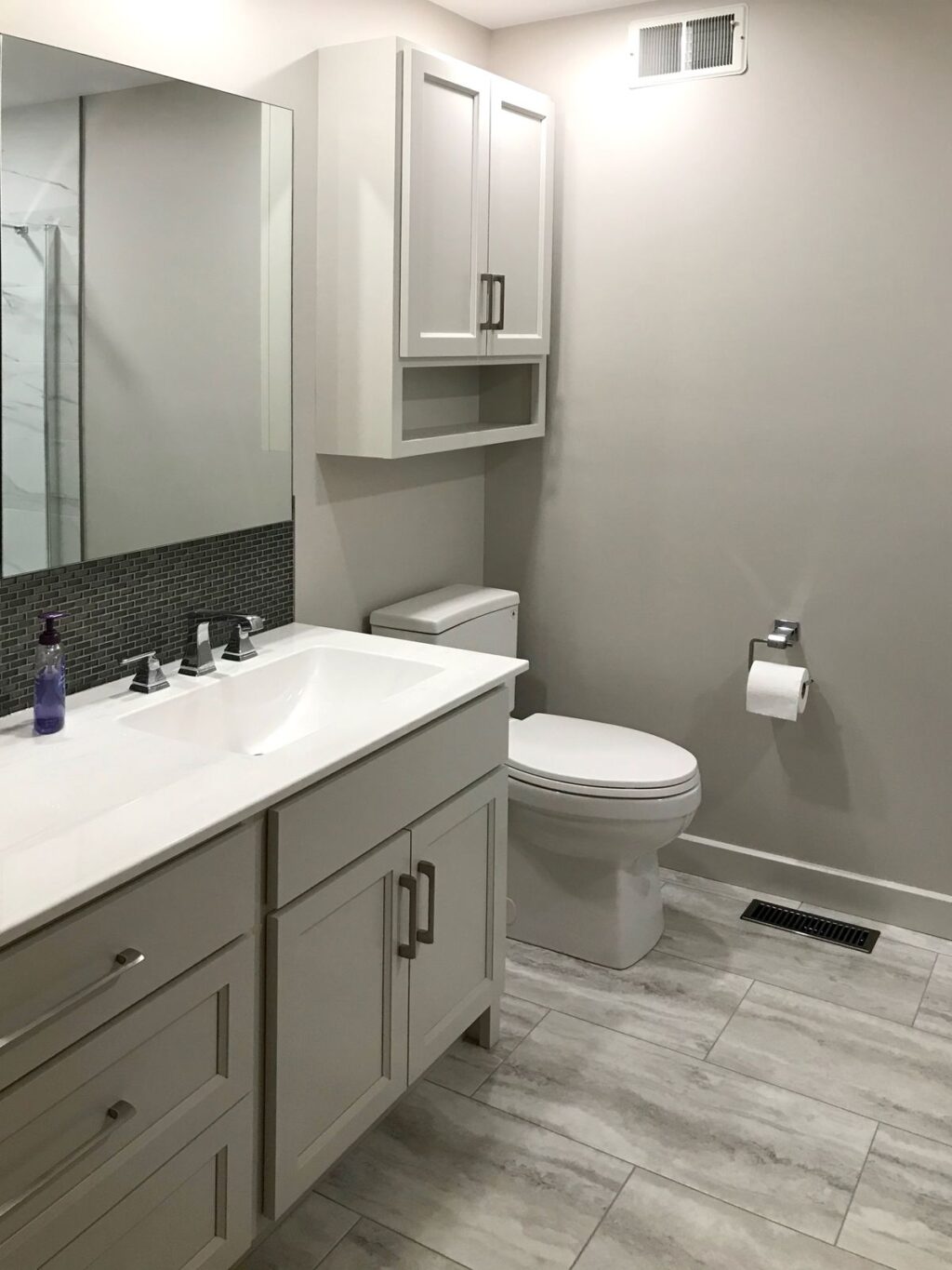 bathroom renovation with custom vanity and tile floor