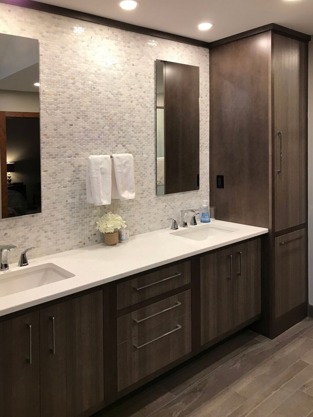 bathroom remodel with custom wood cabinets and mosaic tile backsplash