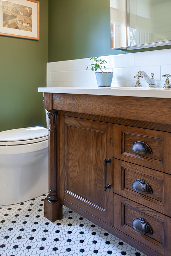 bathroom renovation in vintage look for classic home. wood vanity and hexagonal floor tile