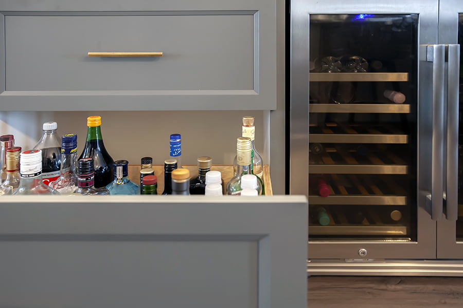 whole home renovation custom bar area home bar with liquor drawer and integrated wine fridge