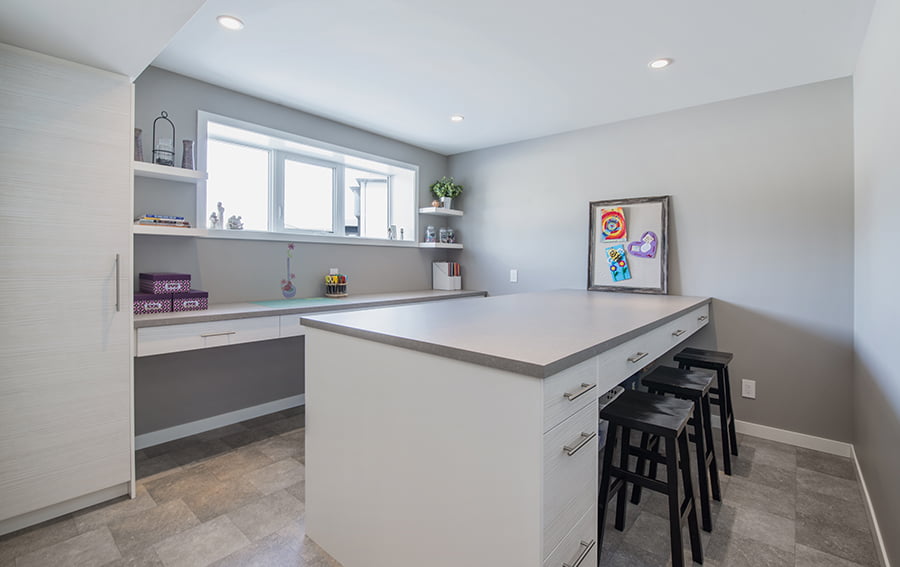 interior design and reno winnipeg custom craft and hobby room with cabinets and large workspace