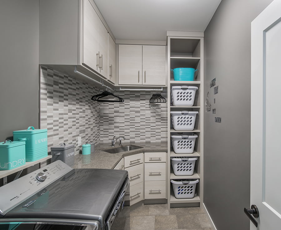 whole home renovation winnipeg laundry room renovation featuring cabinets, and laundry basket shelves