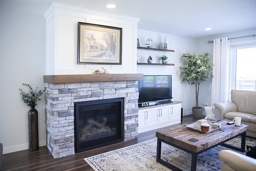 living room renovation custom fireplace with paneled mantle and built in cabinets