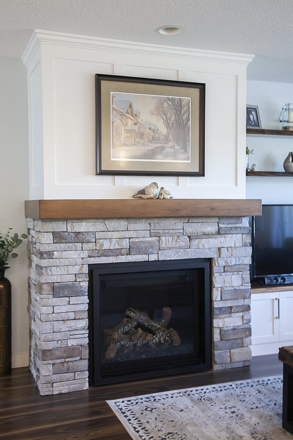 whole home renovation fireplace design with custom mantle and cabinets