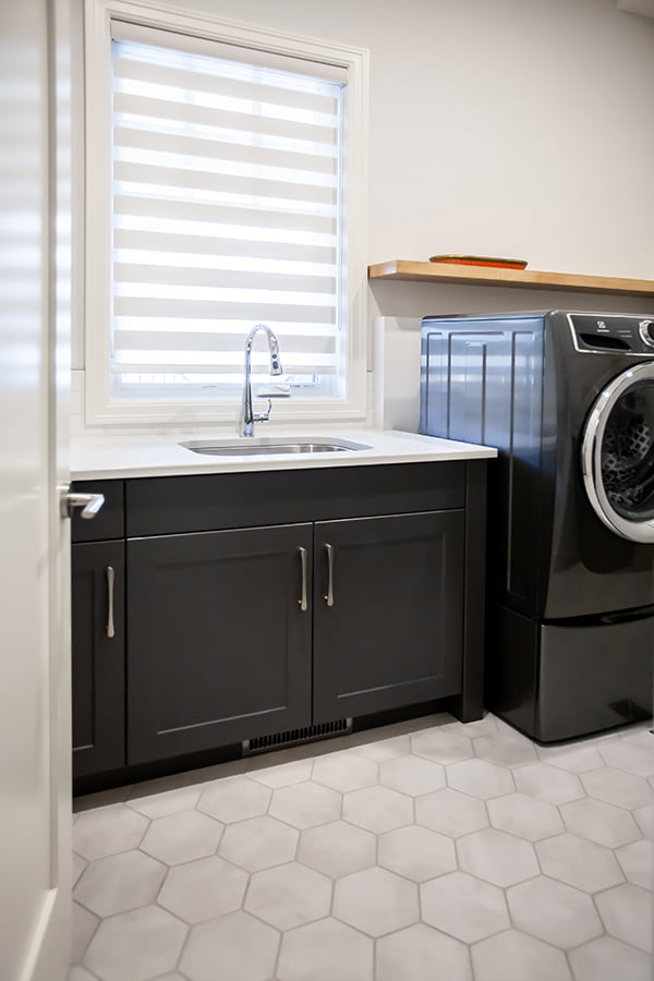 whole home renovation 36 custom laundry room with sink and floating shelf