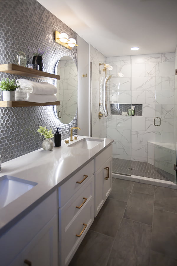 custom bathroom with double sinks and large glass door shower