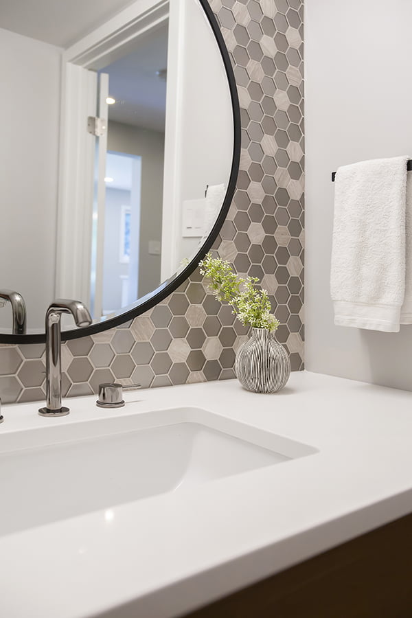 powder room renovation with hexagonal tiled backsplash