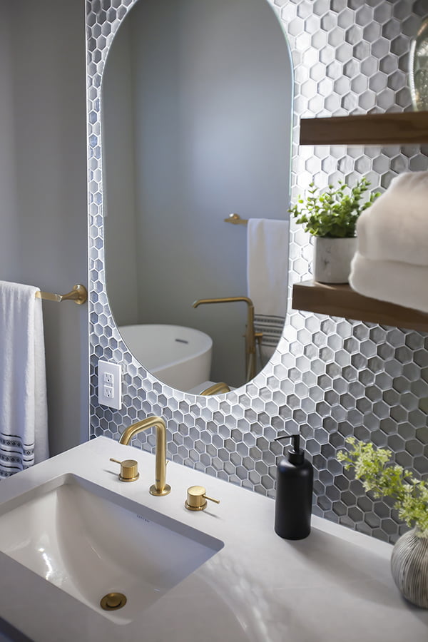 bathroom renovation with backlit mirrors and glass tile