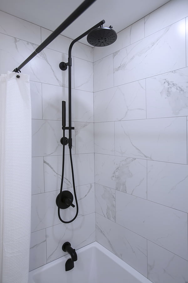 combination bath and shower with black rain showerhead