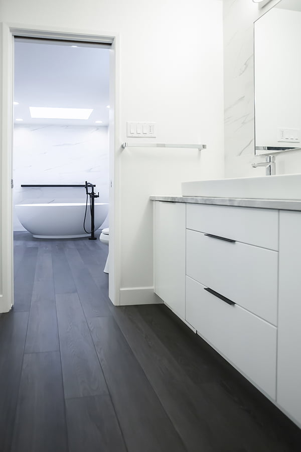 two-room bathroom remodel with large freestanding bathtub