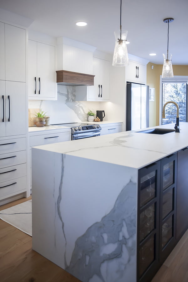 Custom kitchen island with porcelain countertops and waterfall detail